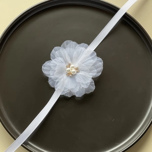 Elegant white chiffon wedding wrist corsage with pearls and sparkling crystals on ribbon