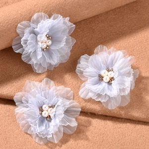 Set of three light blue ruffled fabric flower hair clips with central pearl accents