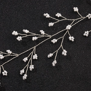 Handmade bridal hairpiece featuring silver wire and white pearl bead flower branches