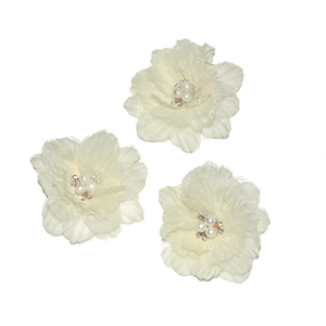 Detailed view of three white chiffon flower hair clips with pearl and rhinestone centers