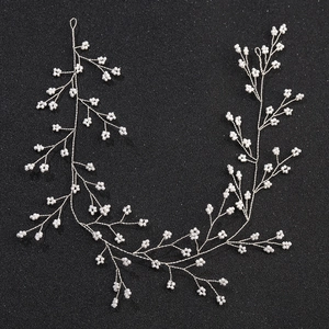 Detailed close-up of handmade bridal vine with silver wire and delicate white beads