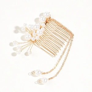 Detail of golden hair comb with white pearls and long hanging bead chain tassels