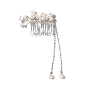 Detail of silver hair comb featuring elegant white pearls and delicate chain tassels