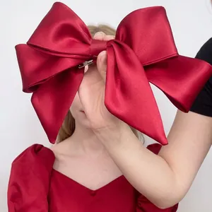 Large red satin layered bow hair clip for weddings and vintage bridal hairstyles