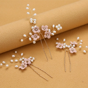 Detail of bridal hair pins set with pink flowers, pearls and crystals on gold wire