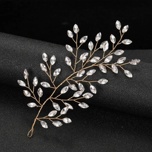 Elegant gold wire bridal hair vine with marquise crystal leaves on black background