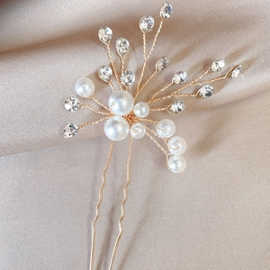 Elegant bridal hair pin with pearls and rhinestones on gold wire for wedding hairstyles