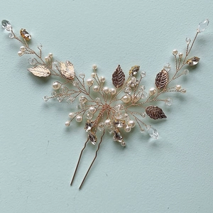 Detail of handmade gold leaf hair pin with white pearls and crystals for bridal styling