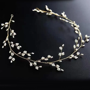 Detailed view of handmade bridal hair vine with gold wire and tiny white pearls