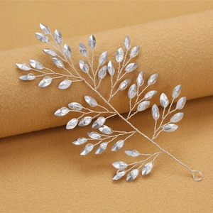 Detail of silver leaf bridal hair vine with marquise crystals and woven metal wire