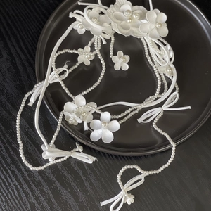 Elegant white satin floral bridal headpiece with handmade petals and pearl tassels