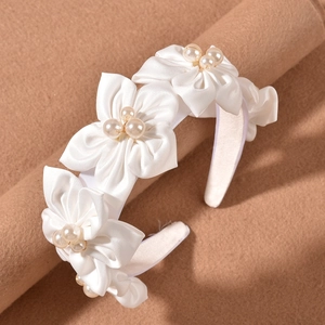 Elegant white satin bridal headband featuring handmade floral petals and pearls decorations