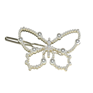 Barrette papillon élégante en métal doré avec perles blanches sur fond blanc pur