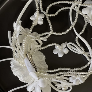 Elegant white satin flower bridal hair clip with faux pearl chains and silk ribbon bow