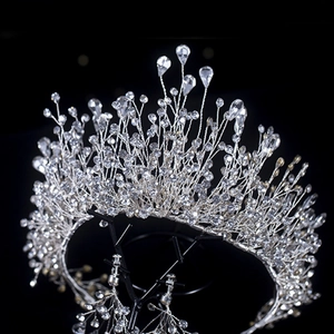 Elegant silver crystal crown and earring set for brides on black background