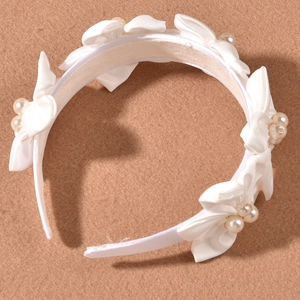 Elegant white satin headband with fabric bows and cream pearls for bridal wedding hair styling