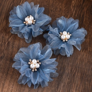 Detailed macro view of 3 blue mesh flower hair clips with faux pearls and rhinestones