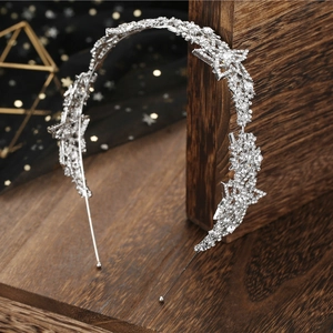 Elegant silver bridal headband with sparkling star-shaped rhinestones on dark wood