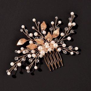 Handmade gold leaf wedding hair comb with white pearls and crystals on black background