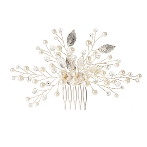 Close-up of bridal hair comb with silver leaves, white pearls and faceted crystal beads