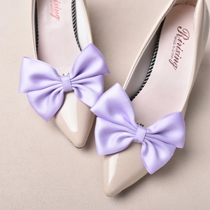 Elegant pointed toe pumps featuring large purple satin bow clips for bridal wedding wear