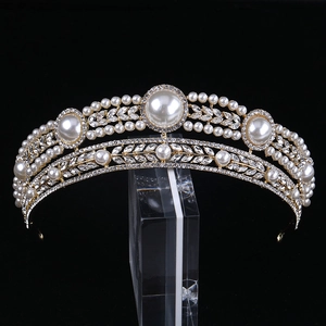 Luxury bridal crown with pearls and crystals on a golden frame for wedding accessories