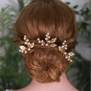 Set of 3 gold leaf hair pins with pearls styled in an elegant updo hairstyle