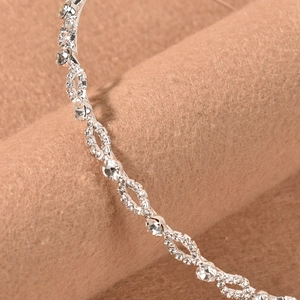 Elegant silver bridal headband with sparkling rhinestones in a wave-like pattern