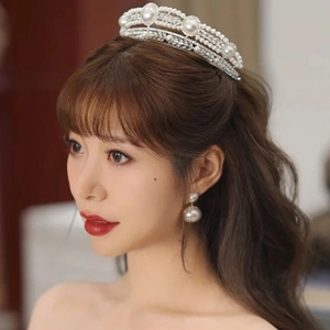 Elegant bridal silver crown with pearls and rhinestones paired with drop earrings