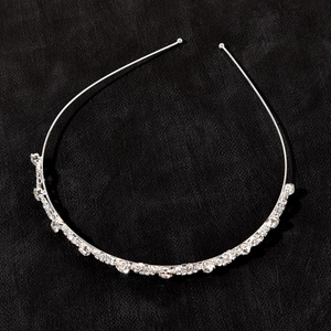 Elegant silver alloy bridal headband with sparkling rhinestones on a black background