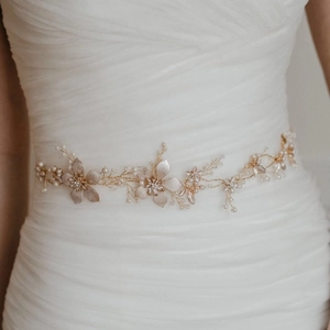 Exquisite bridal waist belt and headband with pearls and rhinestones on white dress