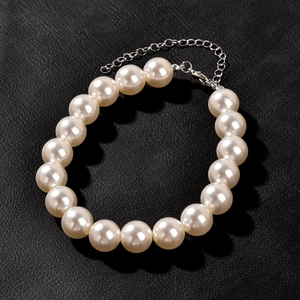 Lolita style cream white pearl bracelet with silver metal chain on black leather background