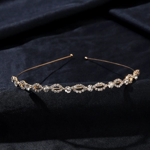 Macro shot of silver bridal headband with sparkling rhinestones on textured dark fabric