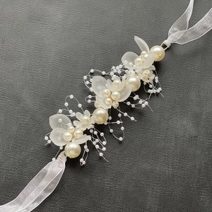 Dettaglio di copricapo da sposa fatto a mano con perle e petali in resina opaca