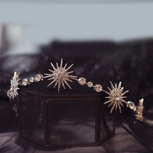 Sparkling star-shaped bridal headpiece with silver crystals on a black background