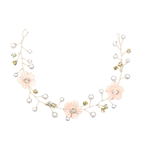 Detail of handmade bridal hair vine with pink fabric flowers, pearls, and gold wire