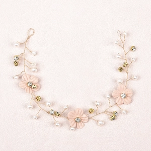 Detail of bridal hair vine with white silk flowers and pearls on golden wire