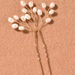 Handmade bridal hair pin with white pearls and gold wire in a branch-like elegant design
