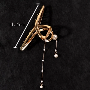 Detailed view of large gold claw clip with pearl tassels and 11.4cm size specification