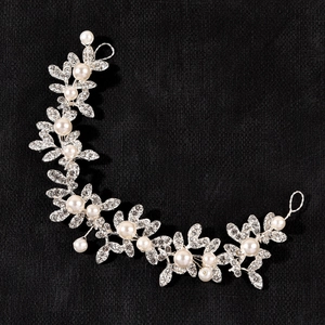 Elegant bridal hair vine with white pearls and sparkling rhinestone leaves on silver wire