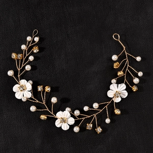 Elegant bridal hair vine with white fabric flowers and pearls on golden wire
