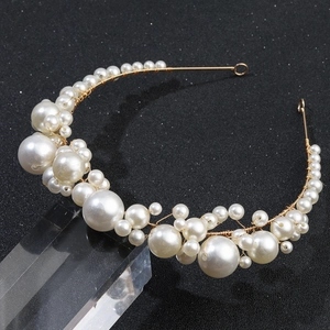 Elegant European style bridal headband with white pearls and gold wire on a black background