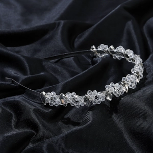 Elegant bridal crystal flower headband with marquise rhinestones on black silk background