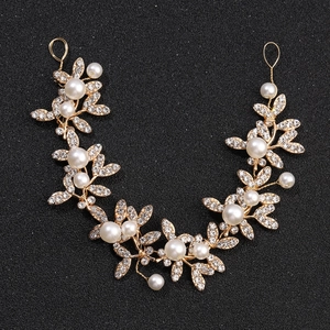 Elegant gold bridal hair vine with white pearls and sparkling rhinestones for weddings
