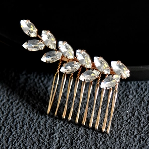 Detail of golden hair comb with marquise cut rhinestones and intricate wire wrapping