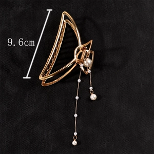 Detail view of gold metal hair claw clip with pearl tassel fringe showing 9.6cm length