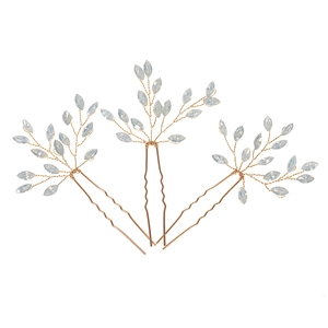 Detail of three-piece gold wire hair pins with marquise opal gems in a floral branch design