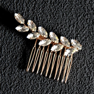 Detail of marquise rhinestone leaf hair comb with gold finish for bridal wedding
