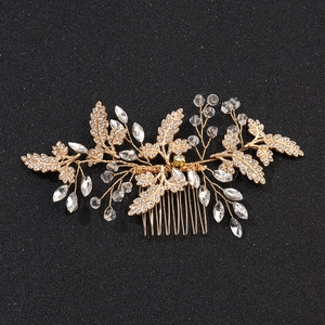 Elegant gold bridal hair comb with crystal beads and metallic leaves for weddings