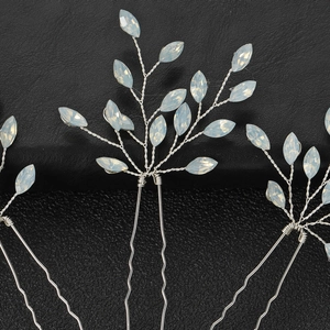 Macro detail of U-shaped hairpins with opal marquise beads and silver twisted wire